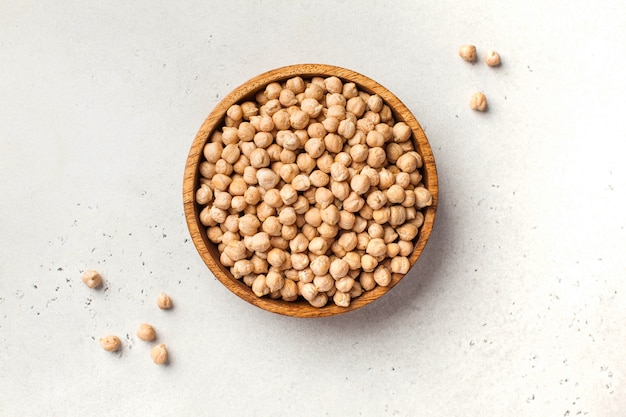 Raw chickpeas in a wooden bowl