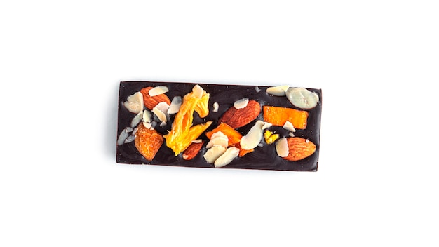 Raw chocolate bar with dried fruits and nuts on white