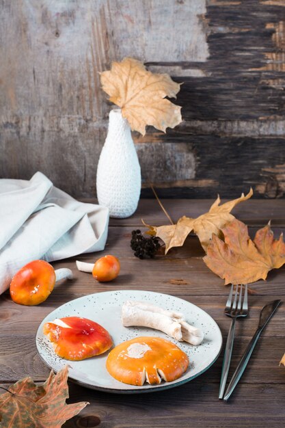 Raw chopped ready-to-eat amanita on a plate on a wooden table. Microdosing and Alternative Medicine. Vertical view