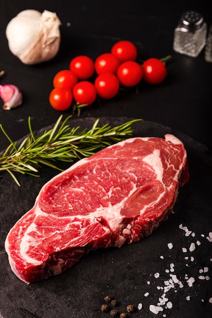 Raw colored beef meat on a slate ready for grilling