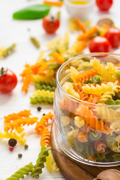 Raw colorful italian fusilli pasta, selective focus.