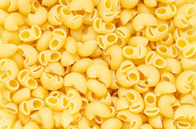 Raw conchiglie pasta Food background An ingredient for traditional Italian food Closeup