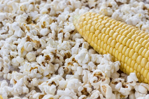 Raw corn cob and popcorn, close-up