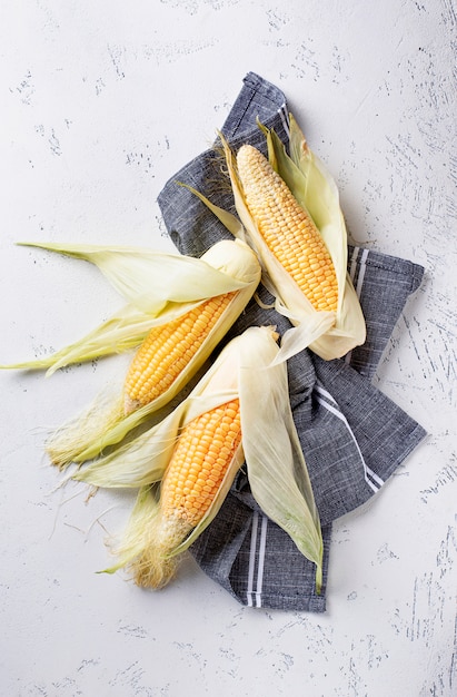 Raw corn on concrete table