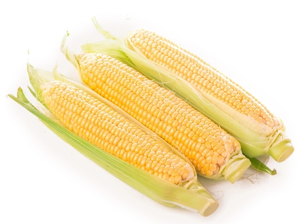 Raw corn with green leaves isolated on white