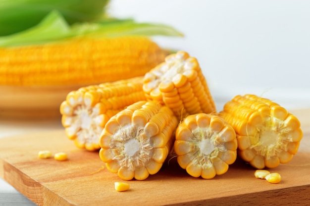 Raw corn on a wooden table