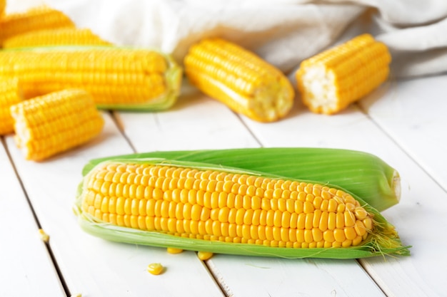 Raw corn on a wooden table