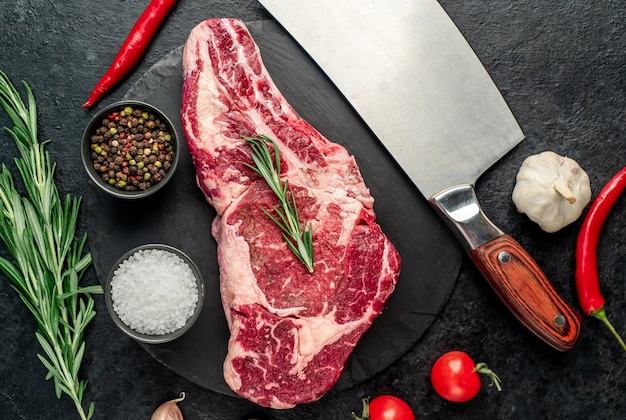 raw cowboy beef steak on stone background