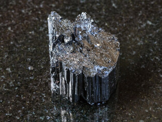 Raw crystal of black Tourmaline Schorl on dark