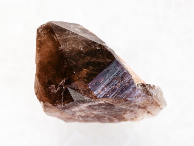 Raw crystal of smoky quartz gemstone on white