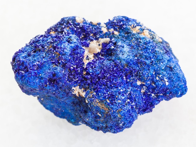 Raw crystalline Azurite stone on white marble