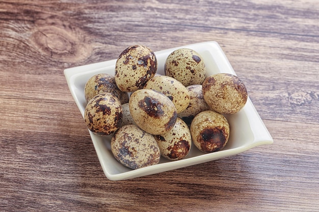 Raw delicatessen quail eggs heap in the bowl