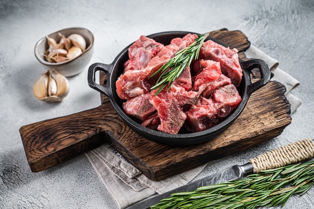 Raw diced meat cubes with bone in a pan