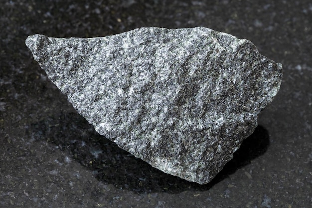 Raw dolerite stone on dark background