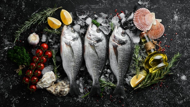 Raw dorado fish on ice On a dark background Top view Flat lay