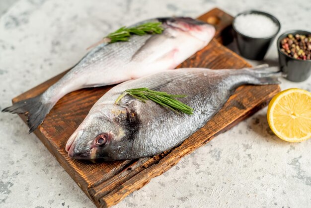 raw dorado fish on stone background