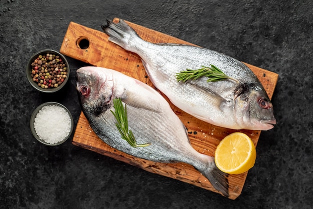 raw dorado fish on stone background