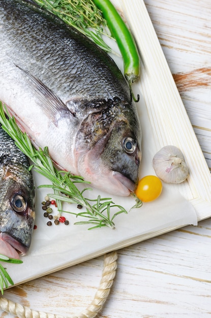 Raw dorado fish with herbs prepared for cooking