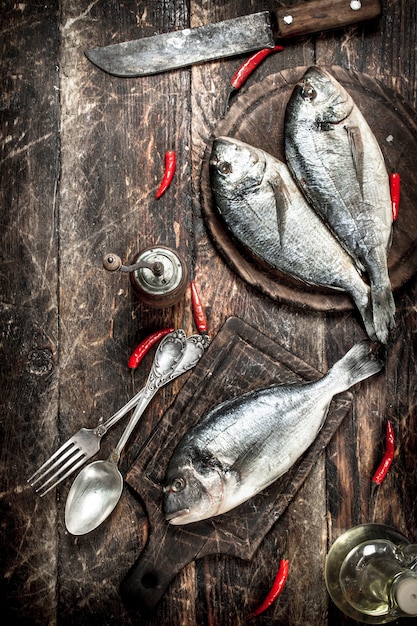 Raw Dorado fish with hot chili peppers.