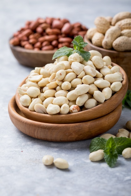 Raw dried fresh peanut nuts on a stone background