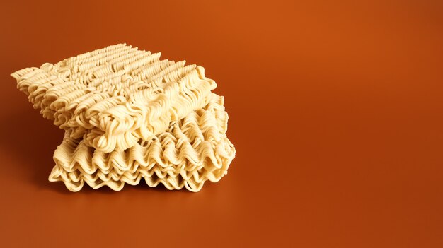 Raw dried instant noodles on a brown background. pasta, for the preparation of which it is enough to pour boiling water and wait a few minutes. Copy space. Vermicelli, spaghetti.