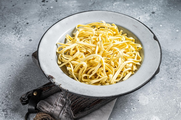 Raw dried spaetzle egg noodle Gray background Top view