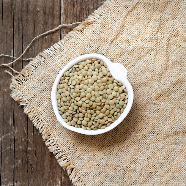 Raw dry Green lentils in a bowl top view