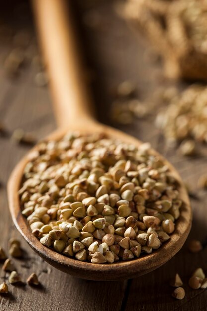 Photo raw dry organic buckwheat in a spoon