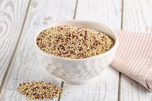 Raw dry quinoa cereal grain in the bowl