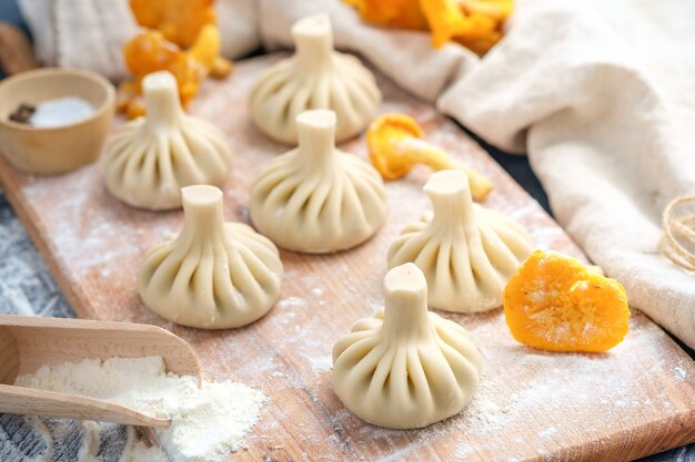 Raw dumplings on a cutting board