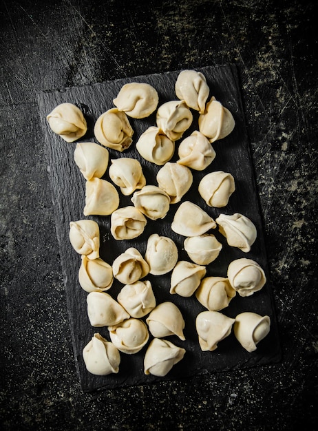 Raw dumplings on a stone board