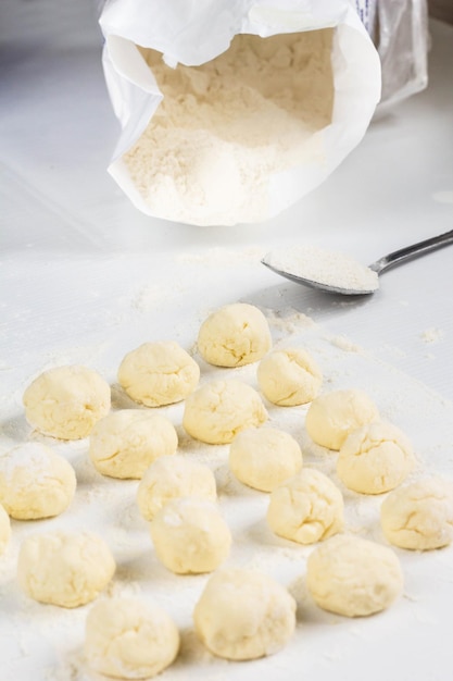 Raw dumplings with cottage cheese on the table