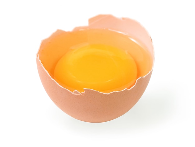 Raw egg tear into half with yolk and albumin