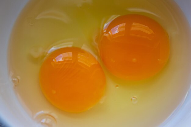 Raw egg yolks in bowl