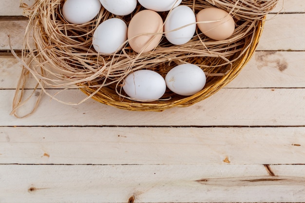 raw eggs in the hay on a wooden floor