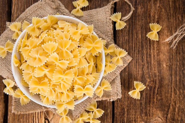 Raw Farfalle on wooden background