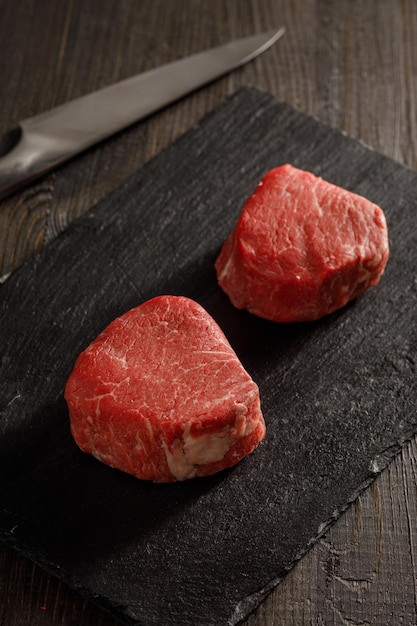 Raw filet mignon on a cutting board