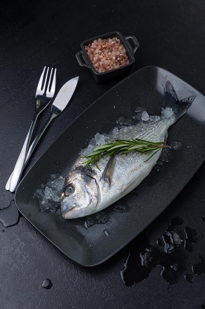 raw fish on a black plate