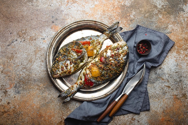 Raw fish dorado stuffed with vegetables for healthy cooking top view