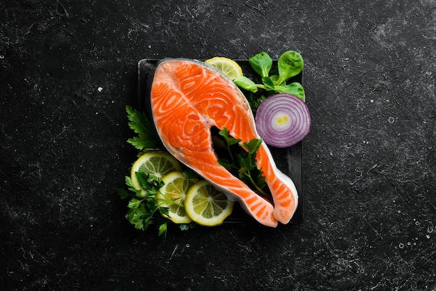 Raw fish steak with parsley and lemon on the table Salmon Top view Free space for your text Rustic style