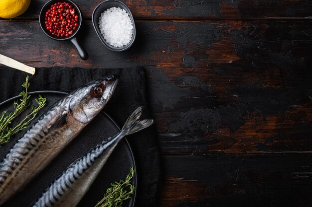 Raw fish with ingredients on wooden table