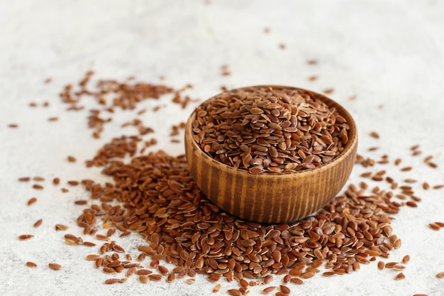 Raw Flax seeds in a wooden bowl close up