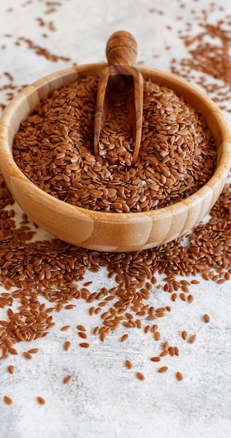 Raw Flax seeds in a wooden bowl close up