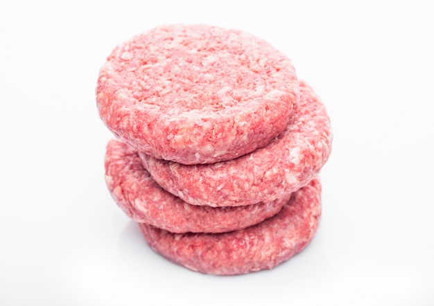 Raw fresh beef burgers with reflection