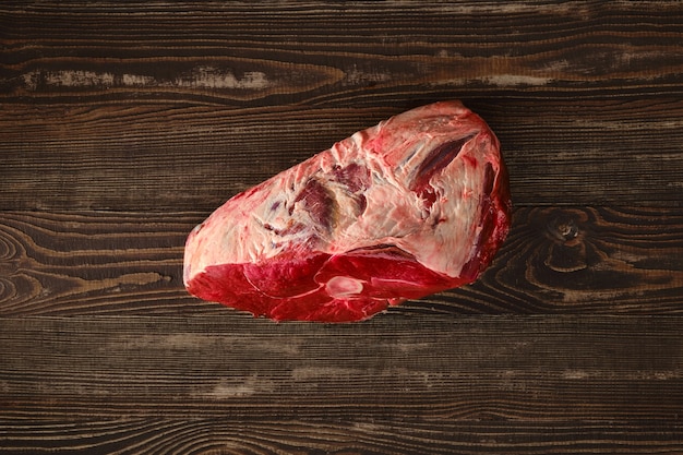 Raw fresh beef shank cross-cut on wooden background