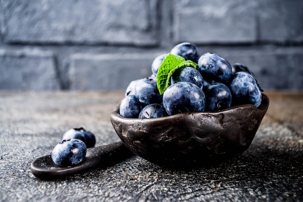 Raw fresh blueberries in small black bowl