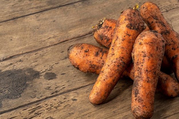 Raw fresh carrots on a wooden table