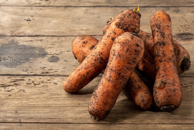 Raw fresh carrots on a wooden table