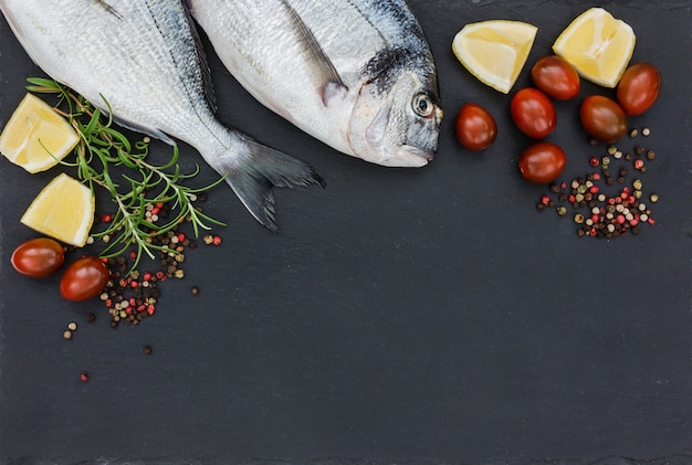 Raw fresh dorado fish on slate cutting board. Top view, copy space.