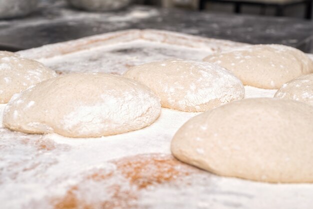 Photo raw fresh dough in industrial bakery